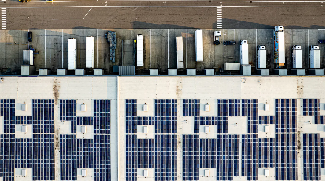 Aerial view of a warehouse roof covered with solar panels