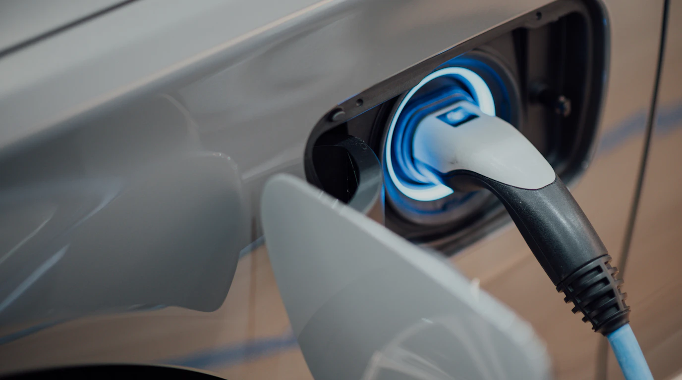 Electric vehicle charger plugged into a car